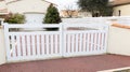 New steel gate white home on suburb street house