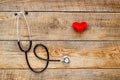 New stethoscope with plush heart on wooden table Royalty Free Stock Photo