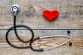 New stethoscope with plush heart on wooden table top view Royalty Free Stock Photo