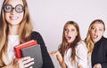 New student bookwarm in glasses against casual group on white, teen drama Royalty Free Stock Photo