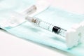 A new syringe filled with a medical product and lying on a table Royalty Free Stock Photo