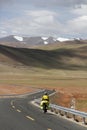 A new tarmac road leads to the foot of the snow mountain in the distanc Royalty Free Stock Photo