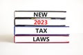 New 2023 tax laws symbol. Concept words New 2023 tax laws on books. Beautiful white table white background. Business new 2023 tax