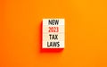 New 2023 tax laws symbol. Concept words New 2023 tax laws on wooden blocks. Beautiful orange table orange background. Business new