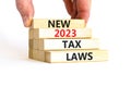 New 2023 tax laws symbol. Concept words New 2023 tax laws on wooden blocks. Beautiful white table white background. Businessman