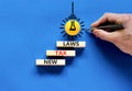 New tax laws symbol. Concept words New tax laws on wooden blocks on a beautiful blue table blue background. Yellow light bulb icon Royalty Free Stock Photo