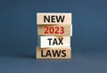 New 2023 tax laws symbol. Concept words New 2023 tax laws on wooden blocks. Beautiful grey table grey background. Business new