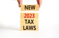 New 2023 tax laws symbol. Concept words New 2023 tax laws on wooden blocks. Beautiful white table white background. Businessman