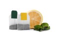 New tea bags with labels, lemon and mint on white background Royalty Free Stock Photo