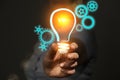 New technology invention concept, innovation and development, engineer in hand holding light bulb with gears icons Royalty Free Stock Photo