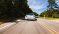 A new Tesla Model 3 all electric car driving down the road