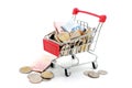 New Thai Baht banknotes and coins in red miniature shopping cart. Royalty Free Stock Photo