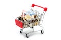 New Thai Baht banknotes and coins in red miniature shopping cart. Royalty Free Stock Photo