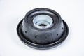 New thrust bearing of front suspension strut of a car on a gray background. The concept of new spare parts and