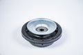 New thrust bearing of front suspension strut of a car on a gray background. The concept of new spare parts and