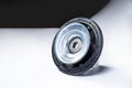 New thrust bearing of front suspension strut of a car on a gray background. The concept of new spare parts and