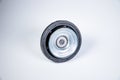 New thrust bearing of front suspension strut of a car on a gray background. The concept of new spare parts and
