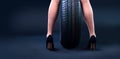 New tire between woman legs. Banner with copy space Royalty Free Stock Photo