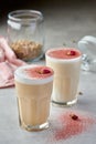 Caramel latte cocktails in tall glass with rose flowers decoration on coloured cream foam
