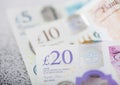 New twenty, ten and five pounds banknotes close up on light background