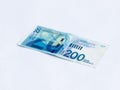 A new type of banknote worth 200 Israeli shekels isolated on a white background