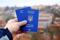 New ukrainian blue biometric passport with identification chip on against town background