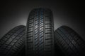 New and unused car tires against dark background Royalty Free Stock Photo