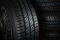 New and unused car tires against dark background Royalty Free Stock Photo