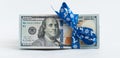 New US one hundred dollar banknote tied with blue christmas ribbon Royalty Free Stock Photo