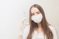 A new vaccine against coronavirus. Girl in a medical mask with a syringe in her hands in a hospital Royalty Free Stock Photo