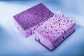 New violet cleaning sponges on white background