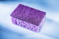 New violet sponge on white background