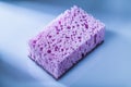 New violet sponge on white surface