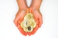 New virtual money: Hands holding Cryptocurrency coin - The Bitcoins / White Background / The future Cryptocurrency / Business and Royalty Free Stock Photo