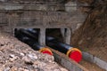 New water pipes being laid down deep into the ground. Construction site, main water line in the ditch