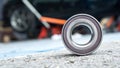 New wheels car bearing on asphalt floor in garage and copyspace