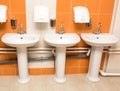 New white ceramic sinks and hand dryers Royalty Free Stock Photo