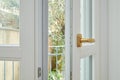 New, white double glazed open window with golden handle