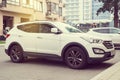 New white Hyundai Santa Fe parked on the street.