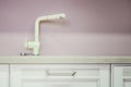 A new white kitchen sink made of artificial stone and a faucet. The concept of modern kitchen interior Royalty Free Stock Photo