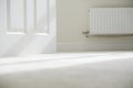 New white radiator white on pale wall house interior Royalty Free Stock Photo