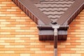 New white rain gutter on a roof with Drainage System, Stone Coated Metal tile, Plastic Siding Soffits and Eaves. Royalty Free Stock Photo