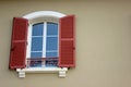 New window with red shutters from an old building Royalty Free Stock Photo