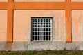 New window with white plastic frame and metal bars protection mounted on old industrial factory building wall Royalty Free Stock Photo