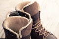 New winter shoes, brown boots with wood background. buying winter shoes Royalty Free Stock Photo