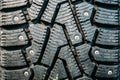 New winter tire with steel thorns, black rubber texture of car wheel Royalty Free Stock Photo