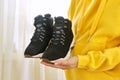 New womens leather black waterproof hiking winter autumn boots in hands of female Royalty Free Stock Photo