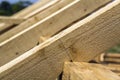 New wooden ecological house from natural materials under construction. Close-up detail of attic roof frame against clear sky from Royalty Free Stock Photo