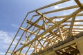 New wooden ecological house from natural materials under construction. Close-up detail of attic roof frame against clear sky. Royalty Free Stock Photo