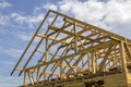New wooden ecological house from natural materials under construction. Close-up detail of attic roof frame against clear sky. Royalty Free Stock Photo